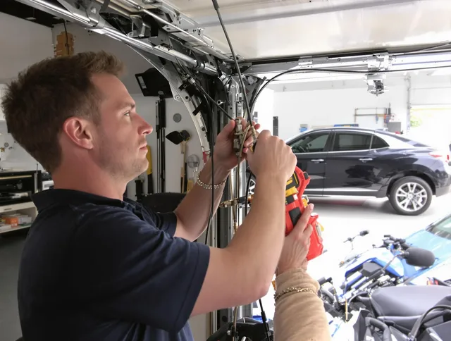 Willimantic Garage Door Repair safety certified technician performing cable replacement in Willimantic