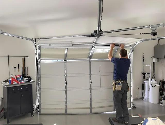 Willimantic Garage Door Repair specialist performing precise section replacement on Willimantic garage door